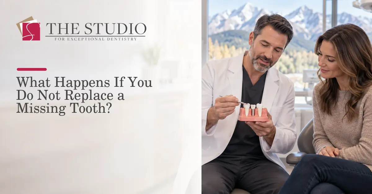 Dentist explaining missing-tooth replacement options using a dental model.
